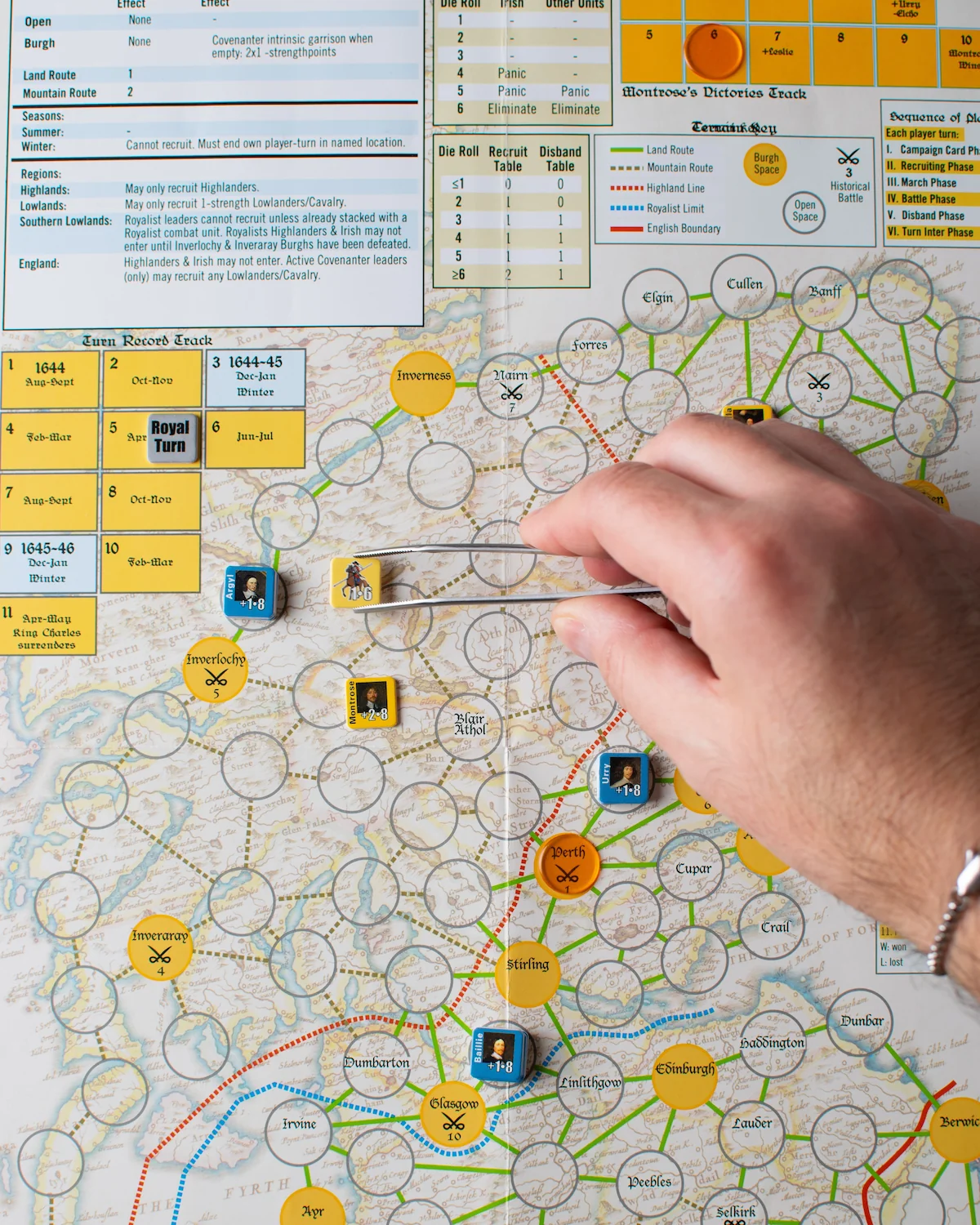 A hand moves a game counter across a map of Scotland depicting Montrose's campaign